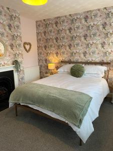 a bedroom with a large bed with a pillow on it at Beautiful 3 bedroom house close to Lowestofts south beach in Lowestoft