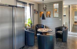 a restaurant with a table and chairs in a room at 4 Bedroom Gorgeous Home In Vimmerby in Vimmerby