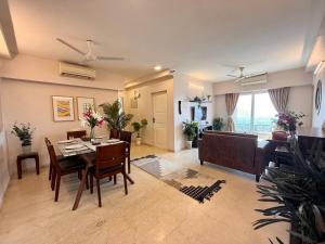 a living room with a table and a couch at 5 Star Luxury Pool, Gym Near Airport BKC in Mumbai