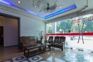 a room with chairs and a table and a window at Valley View Hotel in Lumut