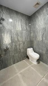 TigarasにあるSejahtera Beach Hotelの石壁のバスルーム(トイレ付)