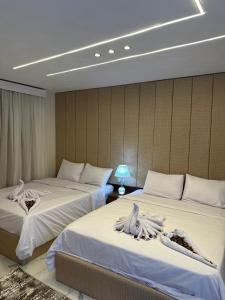 A bed or beds in a room at Inside Pyramids Hotel