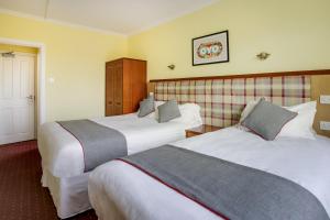 Postel nebo postele na pokoji v ubytování OYO Glenpark Hotel, Ayr Central