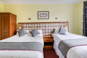 Postel nebo postele na pokoji v ubytování OYO Glenpark Hotel, Ayr Central