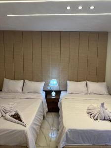 A bed or beds in a room at Inside Pyramids Hotel