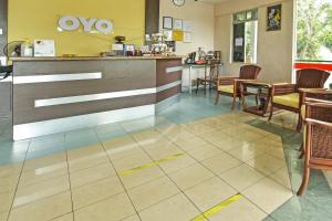 a lobby of a restaurant with a counter and chairs at Hotel O De Perdana Hill in Batu Pahat +45 photos