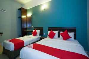 Postel nebo postele na pokoji v ubytování Hotel O Hotel Orchard Inn