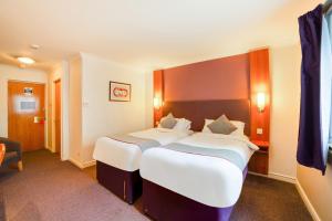 a hotel room with two beds in it at OYO Lakeside Haydock Hotel, St Helens, A580 East Lancs, Garswood Old Road in Saint Helens