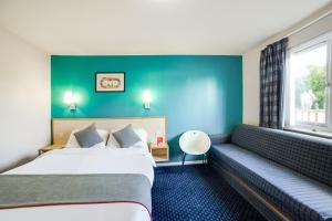 a hotel room with two beds and a window at OYO Sunrise Hotel, A46 N Leicester in Thrussington