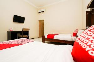 Postel nebo postele na pokoji v ubytování Capital O 1430 Hotel Ratna Syariah