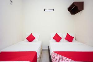 Postel nebo postele na pokoji v ubytování Hotel O Jj Hotel Sitiawan