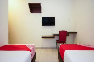 Postel nebo postele na pokoji v ubytování Hotel O Jj Hotel Sitiawan