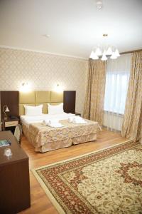 a bedroom with two beds and a rug at Sultan Beibarys in Astana