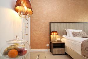 a hotel room with a bed and a bowl of fruit in a glass jar at Studio Old Town in Bucharest