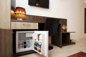 an open refrigerator in a kitchen with a desk at Studio Old Town in Bucharest