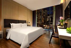 a bedroom with a large bed and a large window at VE Hotel & Residence in Kuala Lumpur