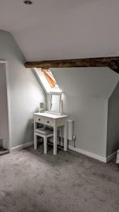 a attic room with a desk and a window at Tyn-Y-Berth Sleeps 27 luxury group accommodation in Tal-y-llyn