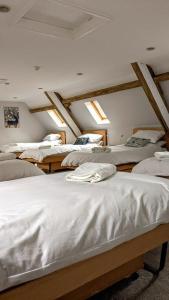a room with several beds in a room with skylights at Tyn-Y-Berth Sleeps 27 luxury group accommodation in Tal-y-llyn
