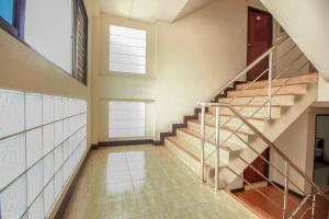 an empty hallway with stairs in a house at OYO 376 Ok Home Airport in Bangkok