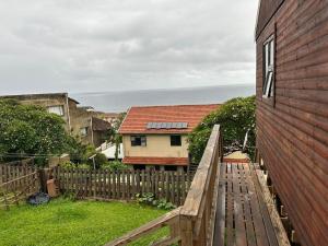 a view of a house with a wooden fence at Dream View Mountain Cabin 2 in Durban