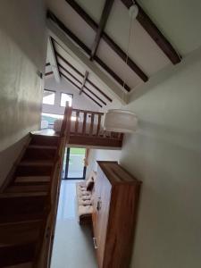 a room with a staircase and a living room with a couch at Mini Ricefilds rooms in Batukaras