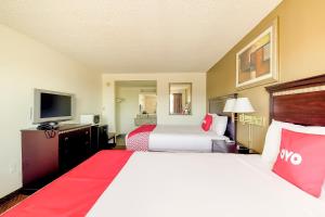 a hotel room with two beds and a flat screen tv at OYO Hotel Eloy Casa Grande near I-10 in Eloy