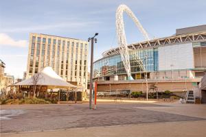 a large building with a ferris wheel in front of it at The Green Man Pub and Hotel by OYO in London