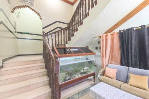 a stairway with a fish tank in a room at Marsa Al Masafar Hotel Apartment in Sur +45 photos