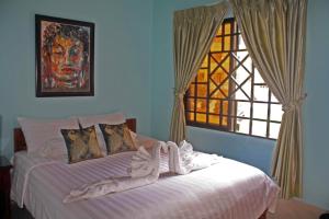 a bedroom with a bed with a window at The Magic Sponge in Kampot