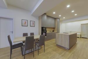 a kitchen and dining room with a table and chairs at Shone apartment old town 2 bedroom in Bratislava