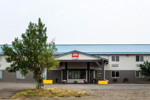 a building with a stop sign on the front at OYO Hotel Shelby MT Hwy 2 & I-15 in Shelby
