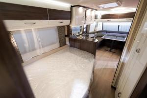 an interior view of an rv with a kitchen and a sink at Domki i POKOJE PLAŻOWE in Darlowko +25 photos