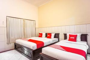 Ένα ή περισσότερα κρεβάτια σε δωμάτιο στο OYO 2180 Vina Vira Hotel +44 φωτογραφίες