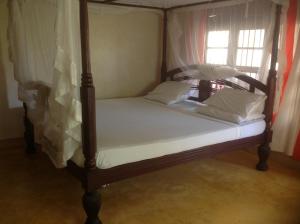 Postel nebo postele na pokoji v ubytování Jannataan Hotel