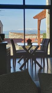 a table and chairs on a patio with a view at Gite Du Buisson in Parent +30 photos