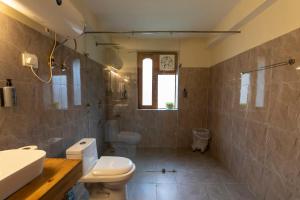 a bathroom with a toilet and a sink at Eden Stay & Cafe in Jibhi +38 photos