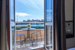 a balcony with a table and chairs and a view at auntieshouseroma in Rome
