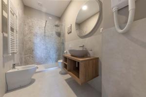 a bathroom with a sink and a toilet and a mirror at auntieshouseroma in Rome +25 photos
