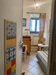 a bedroom with a bed and a desk and a window at I Colori nel Castello in Capranica