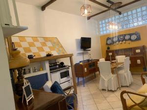 a living room with a kitchen and a dining room at I Colori nel Castello Capranica in Capranica