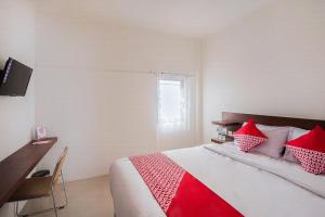 Postel nebo postele na pokoji v ubytování Super OYO 2183 Cibeureum Residence