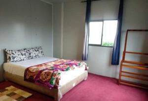 a bedroom with a bed and a window at Kitty cointainer bungalow ambewela - kcb ambewela in Nuwara Eliya