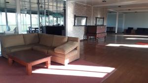 a living room with a couch and a coffee table at Kitty cointainer bungalow ambewela - kcb ambewela in Nuwara Eliya