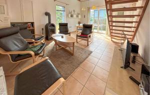 a living room with chairs and a tv and a table at Seebrise in Süssau