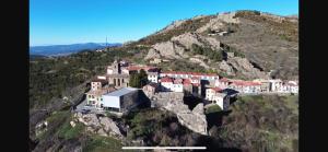 a village on the side of a mountain at Hostal Don Santiago Ramon y Cajal in Petilla de Aragón +13 photos