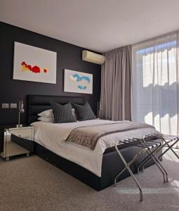 a bedroom with a large bed and a window at Luxury Penthouse with Private Pool in Cape Town +17 photos