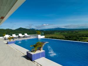 a swimming pool with a view of the mountains at Cabral Hills Ph in Nasugbu