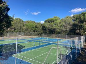 a group of tennis courts with nets on them at Appartement Piscine et pinede - Wifi in Saint-Raphaël