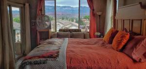 a bedroom with a large bed with a large window at The Zion House - Affordable Bedrooms in Hurricane