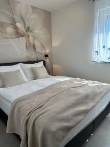 a large bed in a bedroom with a window at APARTMAN SUNSIDE2 NIN in Nin +17 photos